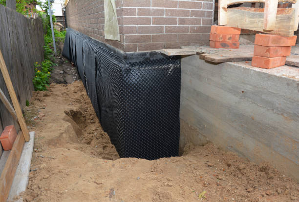 Happy homeowners after waterproofing job in Clio